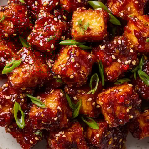 A plate of food with the name Swicy Maple-Gochujang Sticky Tofu Nuggets.